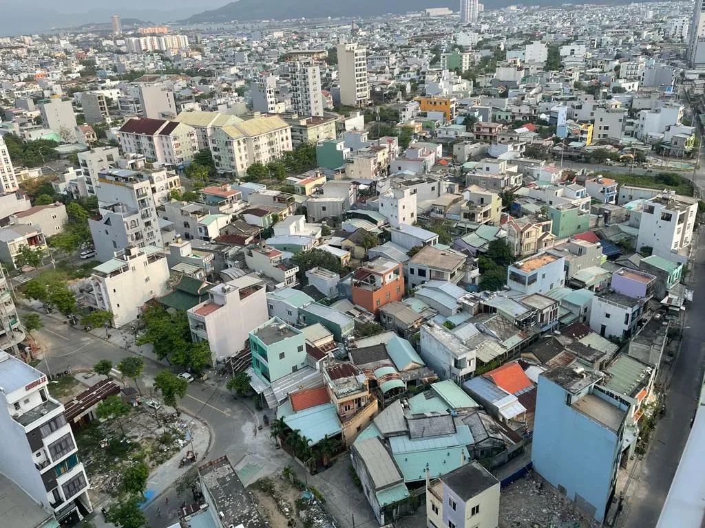 Dense self-built low-rise housing seen from above in a fast-growing Asian city