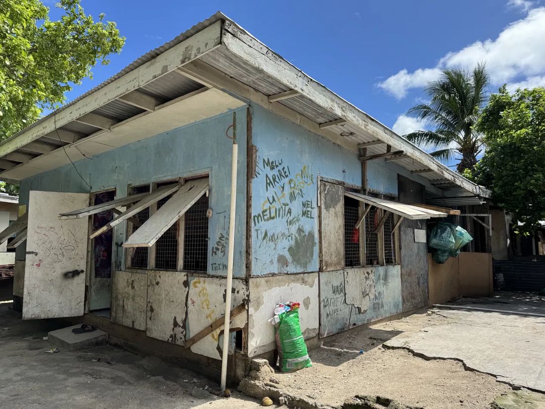 Weathered single-storey housing stock with peeling paint in a Pacific island town